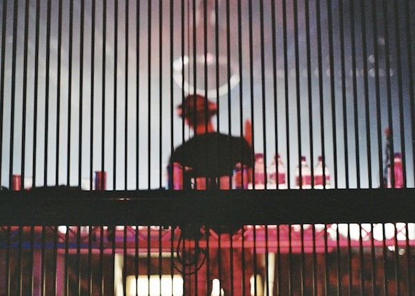 Photo22_21A Blurred photo of a person on a stage taken from behind bars, demonstrating the use of vertical lines in photography composition