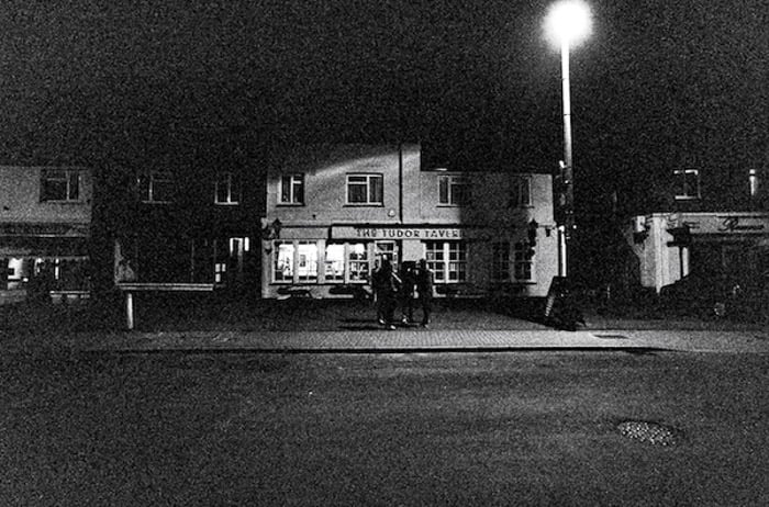 A dark grainy street photography shot