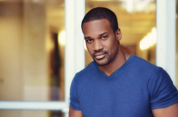 A portrait photo of a male model indoors