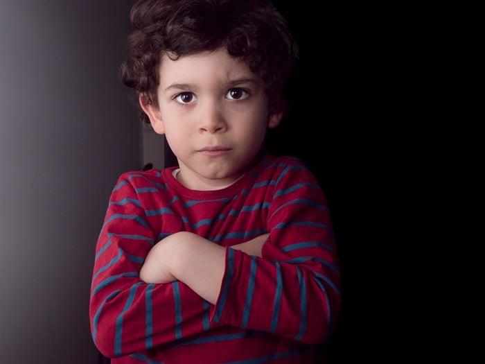 Portrait of young boy taken with on-camera flash bounced off of a white wall