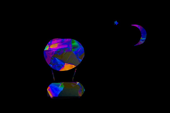 Photoelasticity over a handmade black paper filter mask.
