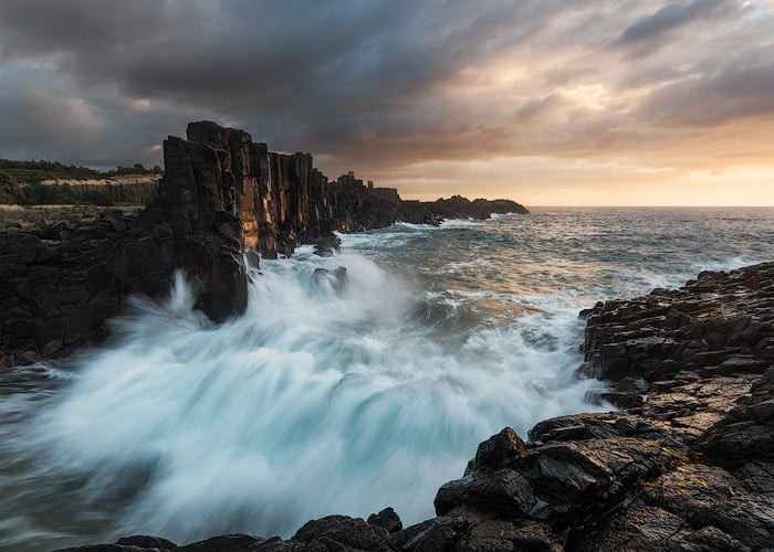 Dramatic seascape photography of rushing wave s at a rocky coast