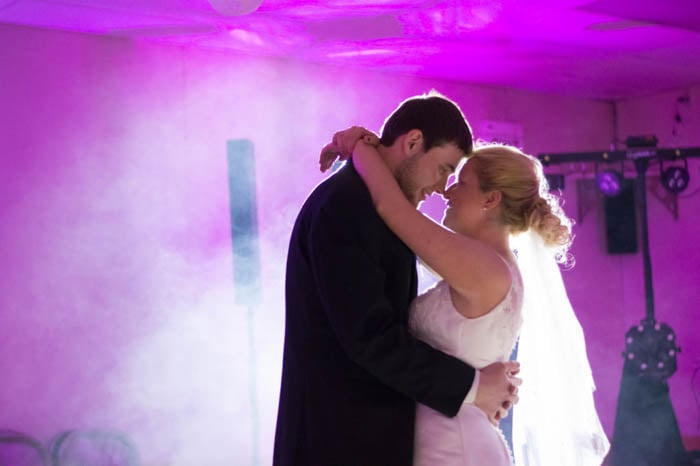 Candid portrait of the bride and groom dancing at the reception