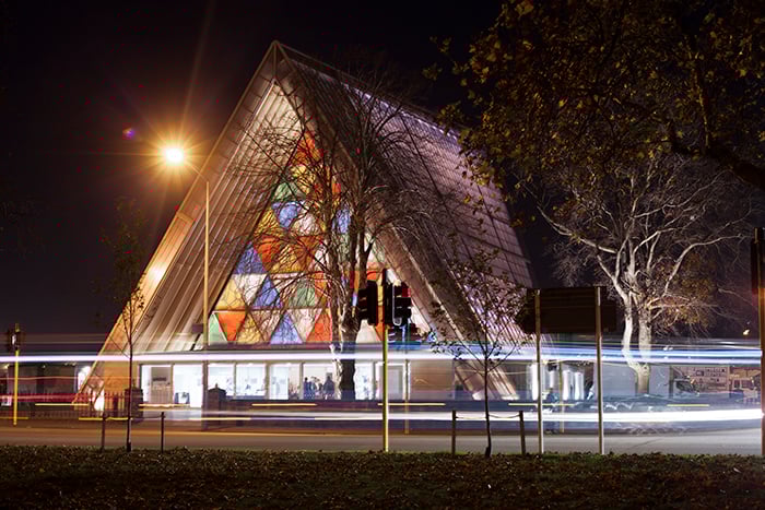 Front view of the brightly colored Transitional Cathedral (aka 'Cardboard Cathedral'), New Zealand, at night. Architecture Photography.