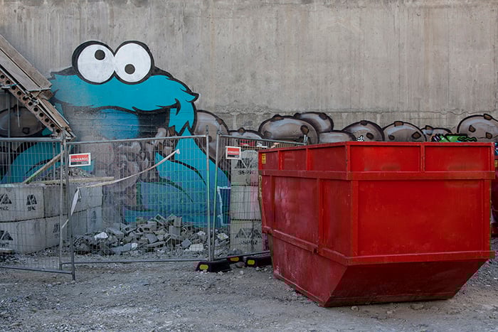 Graffiti of cookie monster character on a wall behind a building site. Creative street photography