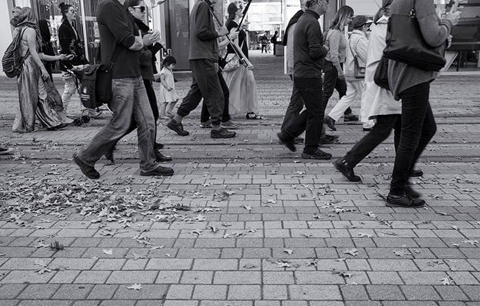 Black and white street photo of a group of people walking. Creative street photography