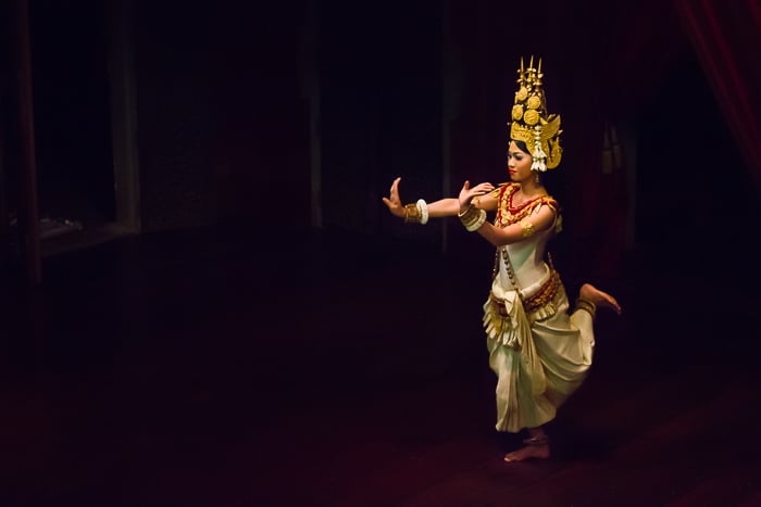 Atmospheric travel photography of a girl dancing in a dimly lit room