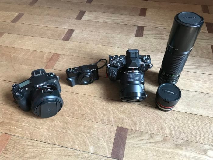 Shot of a Sony RX10 (left), Sony RX100 Mk ii (center) and Olympus OM-D EM-5 Mk II + a couple of lenses (right).