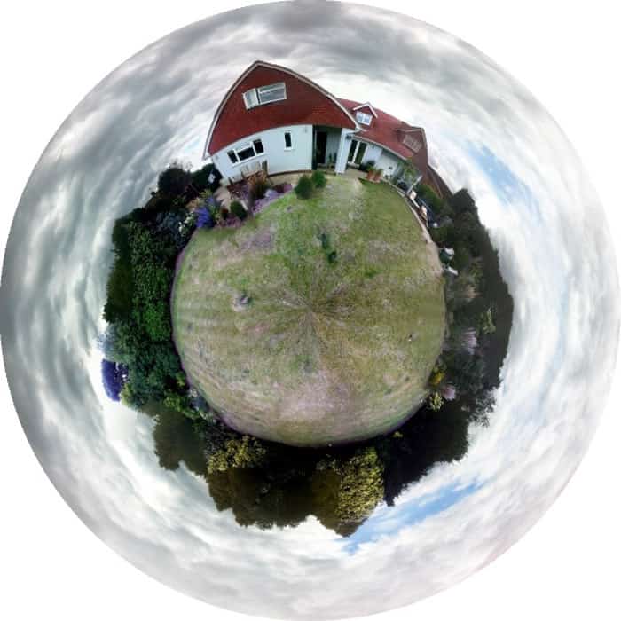 A mini globe panorama of a house and garden compact in a circular shape