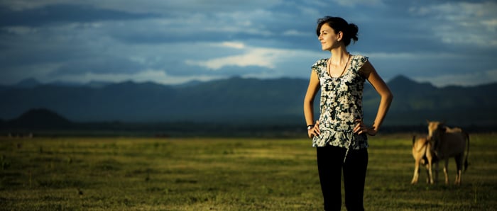 Atmospheric shot of a girl standing in a countryside area 