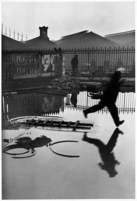 A Henri Cartier-Bresson photo of a man jumping into a puddle - composition techniques