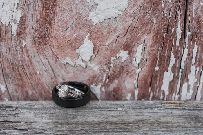 A close up shot of two wedding rings on a wooden background