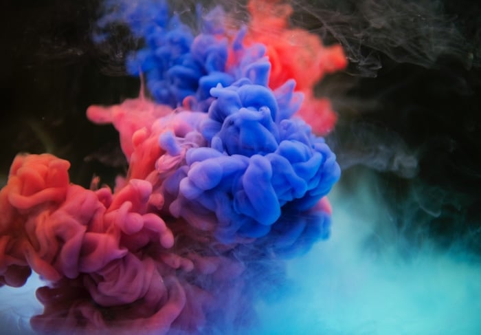 Colorful clouds of smoke against a dark background