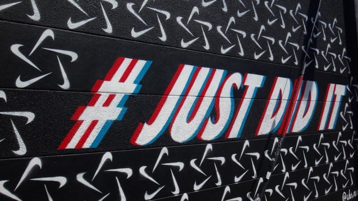 Wall graffiti reading '#justdidit'