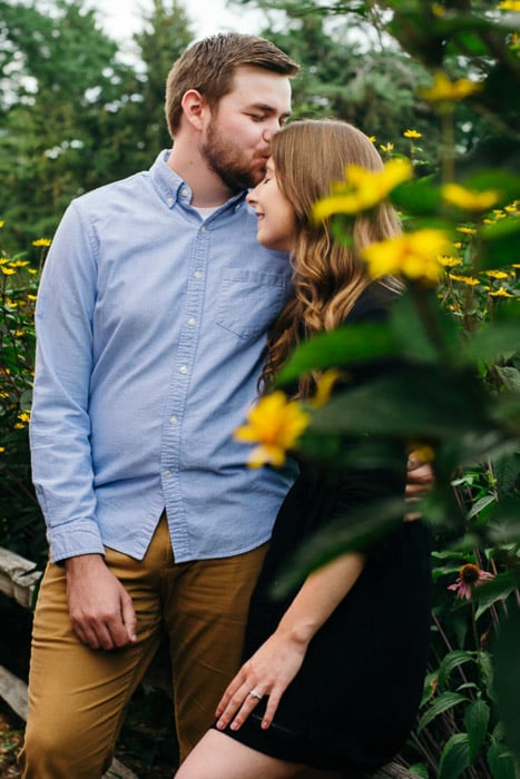 A couple embracing in a natural relaxed pose in a forest setting