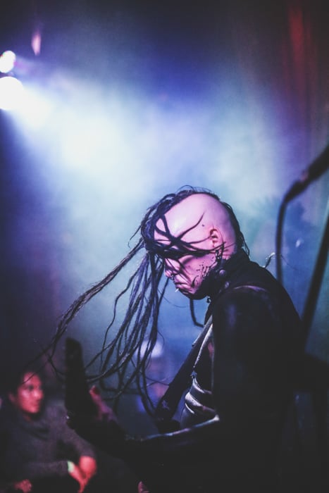 A live concert photography shot of a guitarist onstage