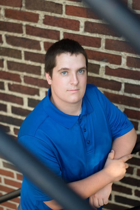 A portrait of a young man posing outdoors with beautiful blurred background