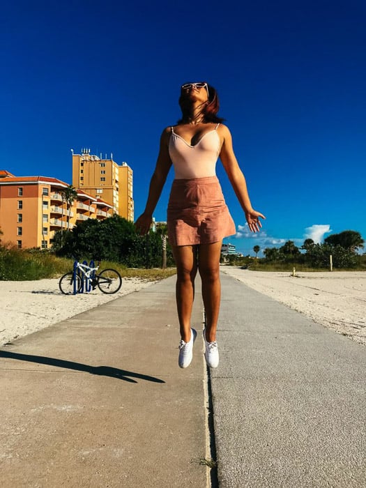 An action shot of a young girl jumping, shot using iphone burst mode