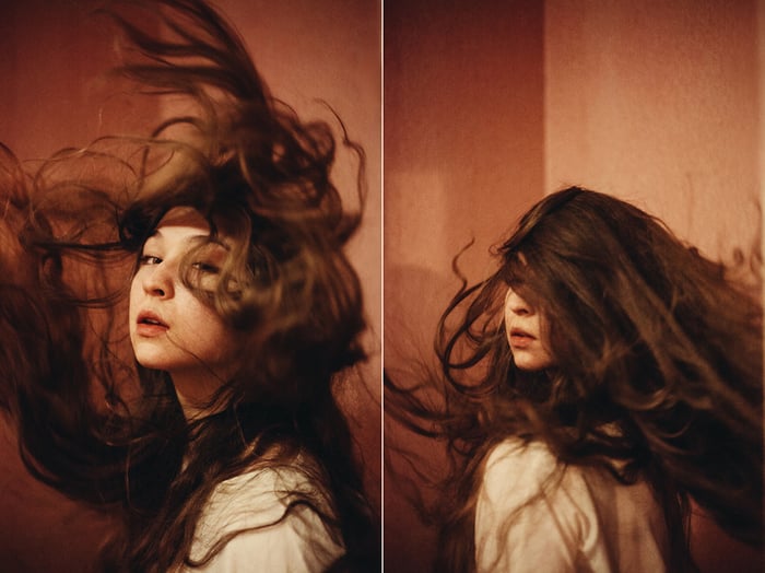 A diptych portrait of a brunette female model reflected in a mirror 