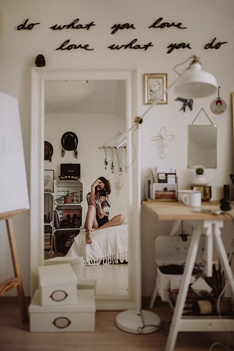 A portrait of a brunette female model reflected in a mirror 