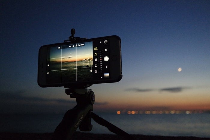 An iPhone on a tripod taking a night time photo 