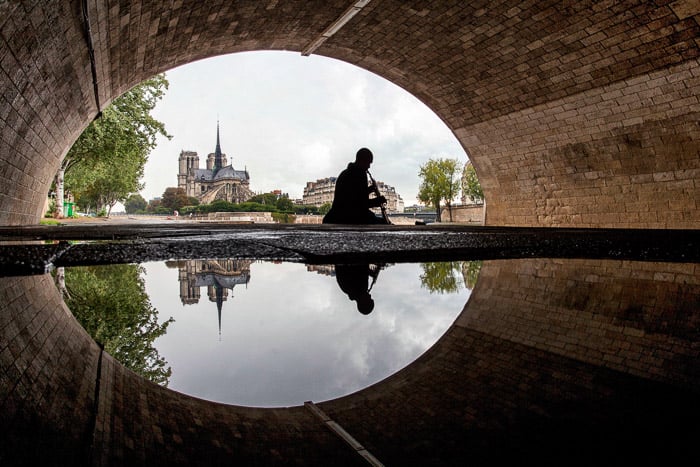 An interesting viewpoint of the Notre Dame from under a bridge.