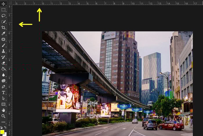A cityscape, featuring a street with cars and buildings in the background in a photo editing software. 