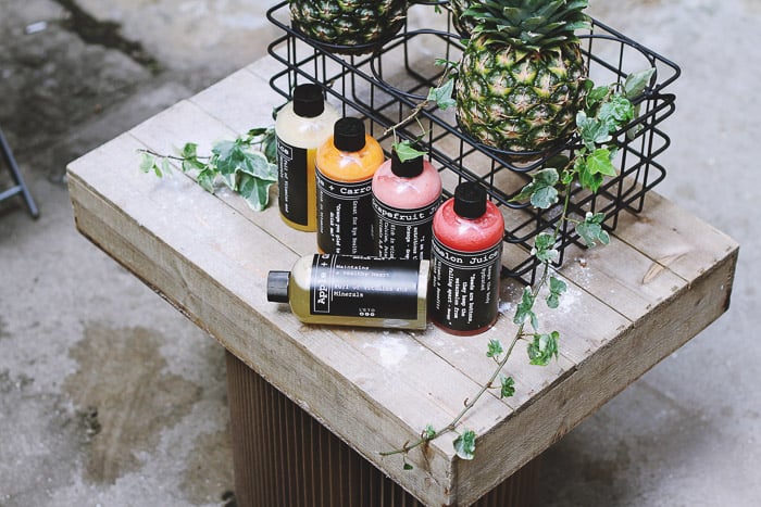 A product photography shot of a cosmetics on a rustic wooden table