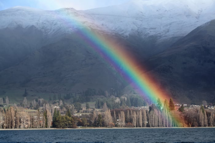 Part of a rainbow in front of an impressive landscape - pictures of rainbows