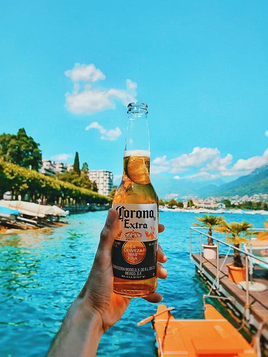 A bottle of corona beer shot against a tropical background - beer photos