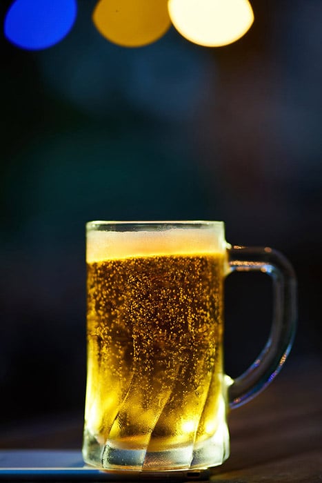 A product photography shot of a pint of beer