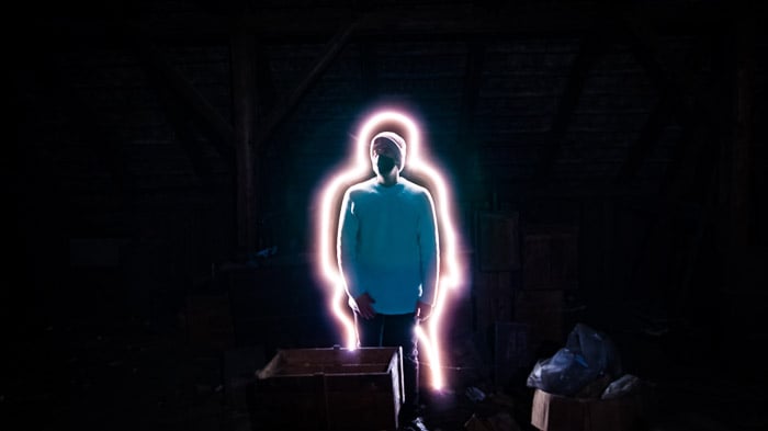A creative portarit of a man with a line of light painting surroundeing him, shot using LED light painting tools