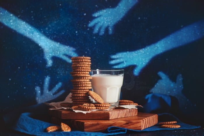Creative food still life including milk and cookies