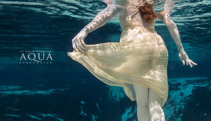 Dreamy underwater portrait of a female model swimming