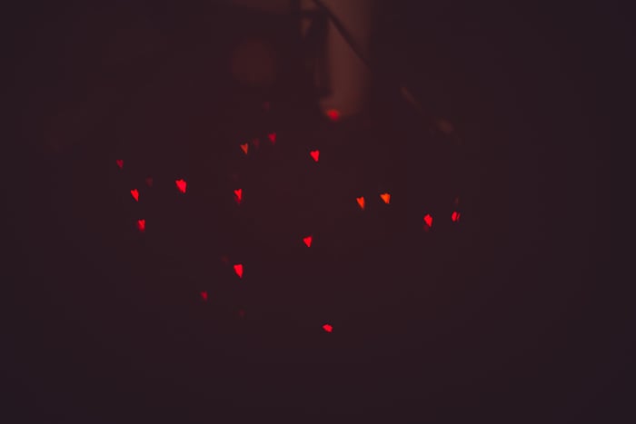 pretty heart shaped bokeh lights on dark background