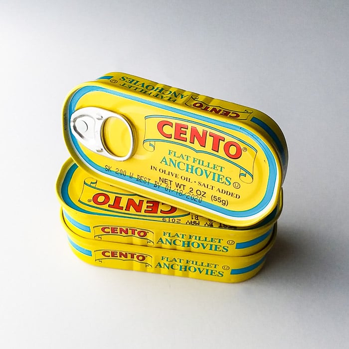 smartphone product photography shot of cans of anchovies on white background