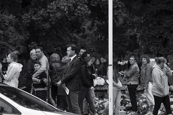 A news reporter at a floral tribute in Christchurch, New Zealand, following a terrorist attack.