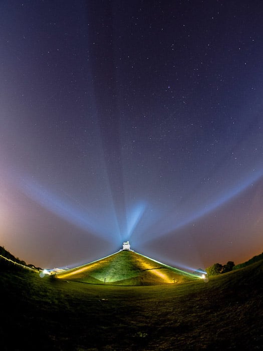 Atmospheric night photo of a building with concave horizon shot with a fisheye lens