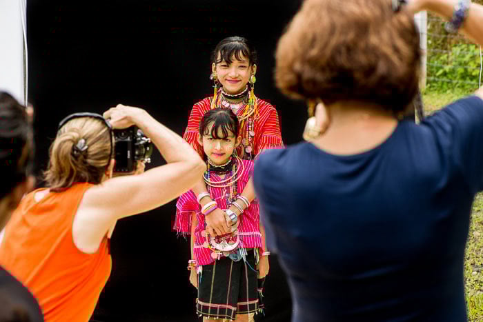 Two girls posing for photographers against a black background - how to start a photography group