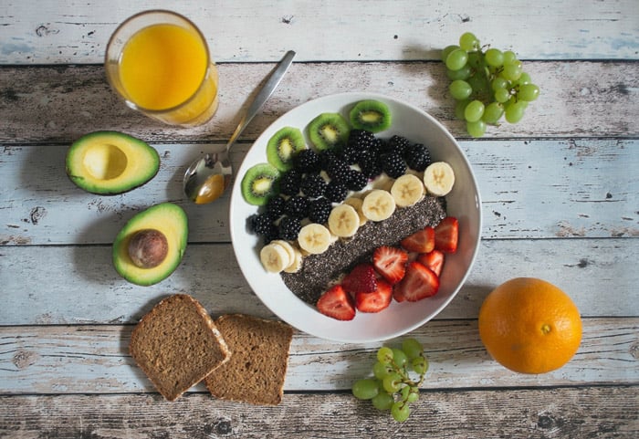 Overhead shot of bowl of fruit on wooden table