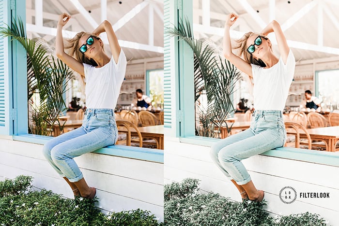 A woman on a blue bench, posing with sunglasses.