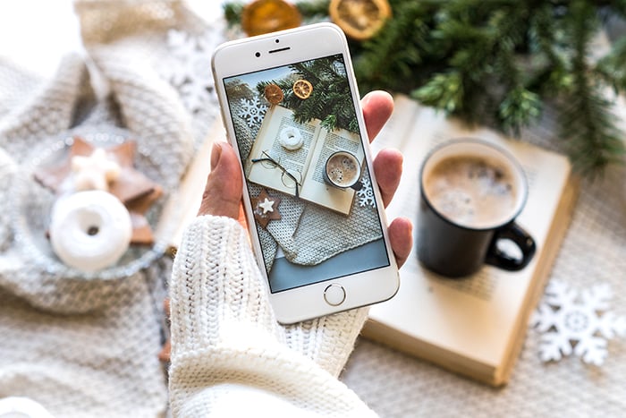 a person staking a smartphone still life photo for instagram 