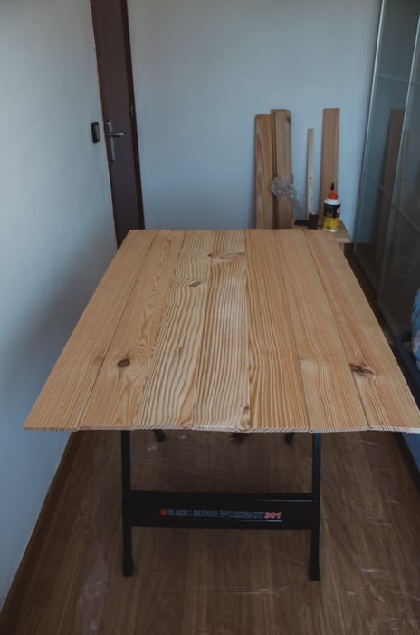 a person making a DIY wood backdrop for photography