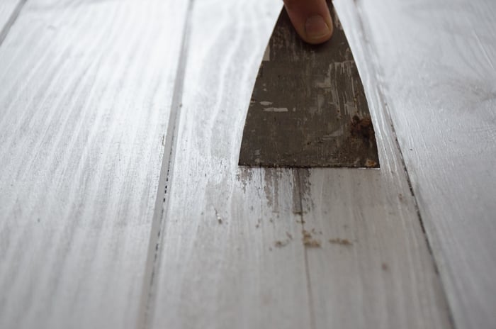 a person making a DIY wood backdrop for photography