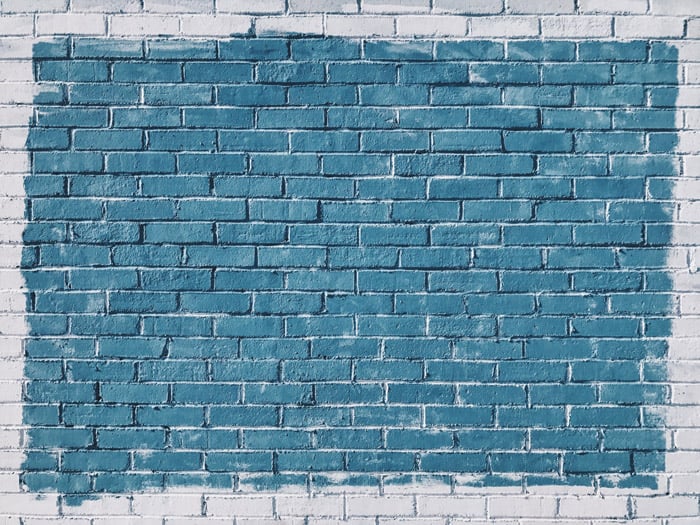 A textured brick wall painted blue and white - composition geometry