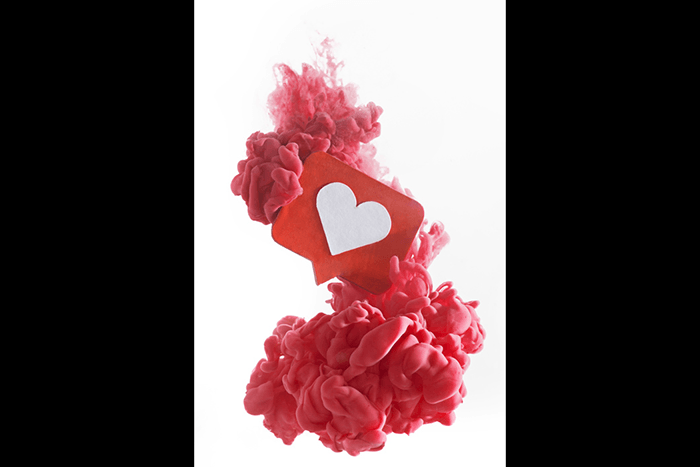 An abstract pink cloud using colorful paint in water photography technique with a heart sign