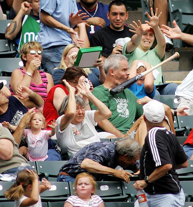 Photo of a baseball bat hitting the face of a man