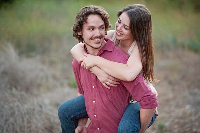  portrait of a couple trying the piggy back engagement photo poses outdoors