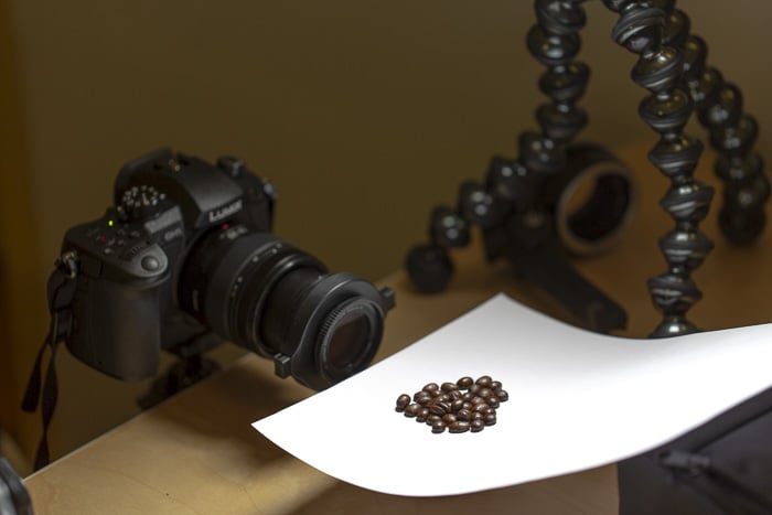 a dslr on a tripod setup to shoot macro photos of coffee beans