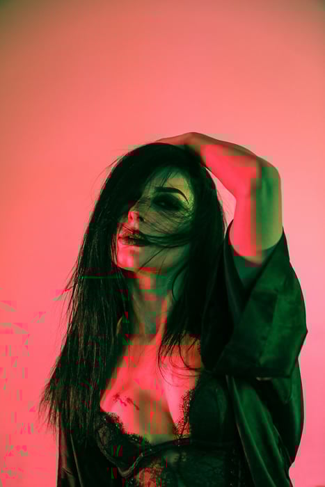 Boudoir photo of a woman in pink lights